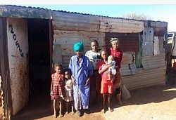 Gogo Motlhanke with some of her family members at the old shack.