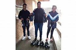 Morare High School principal Mmalekwakwe Moeketsi with some of the learners who received school shoes Rebaona Tau and Kgomotso Tau.